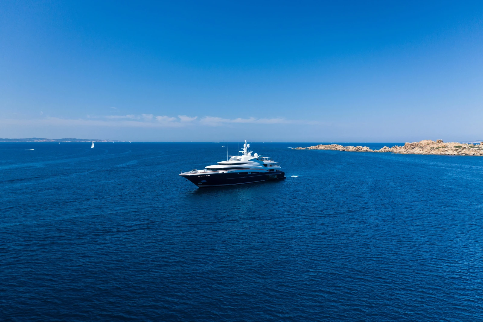 A superyacht underway on open coastal water