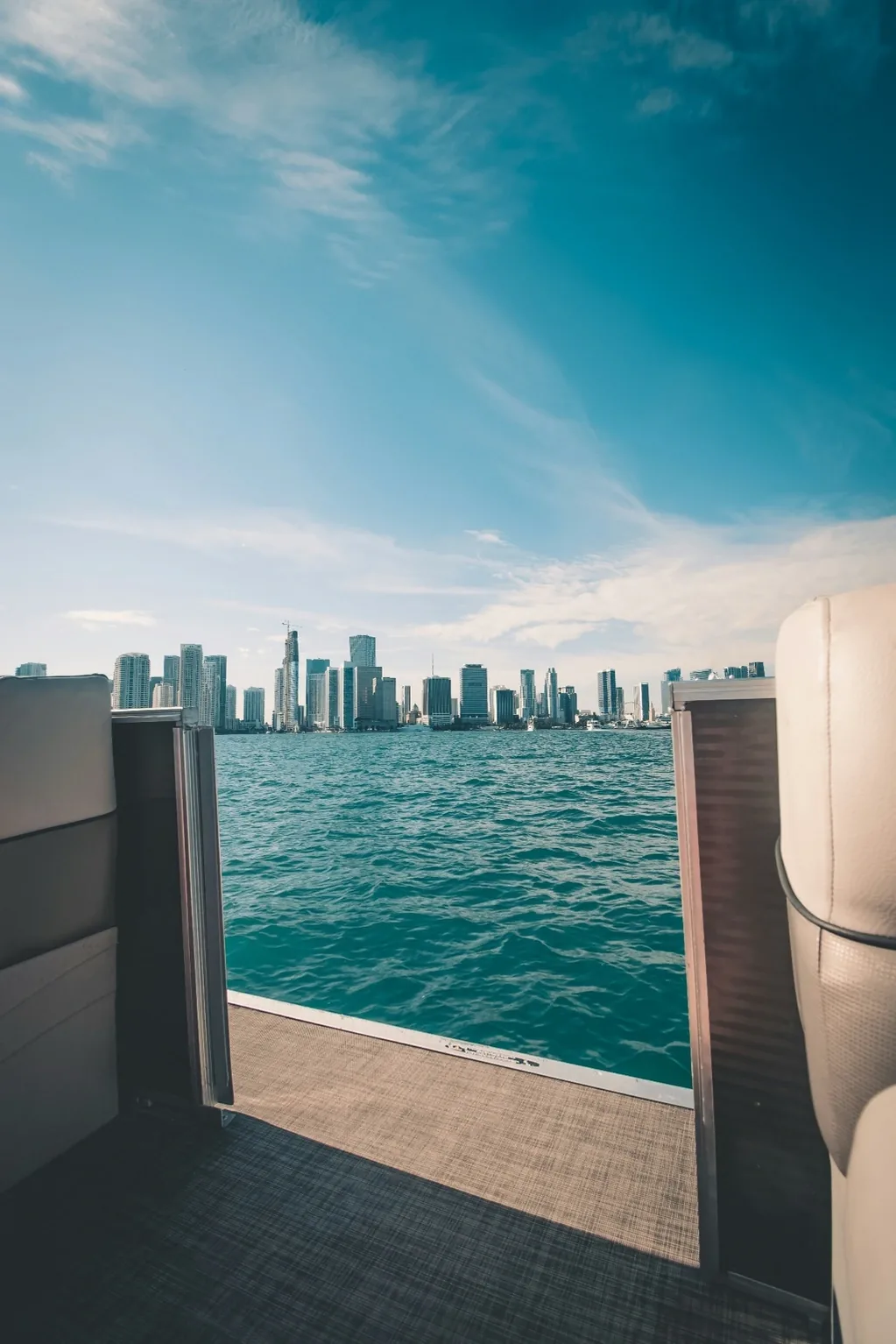 The aft deck of a yacht framing the Miami skyline beyond
